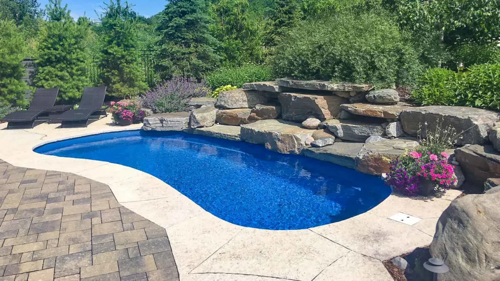 Brand new swimming pool installation in a landscaped backyard.