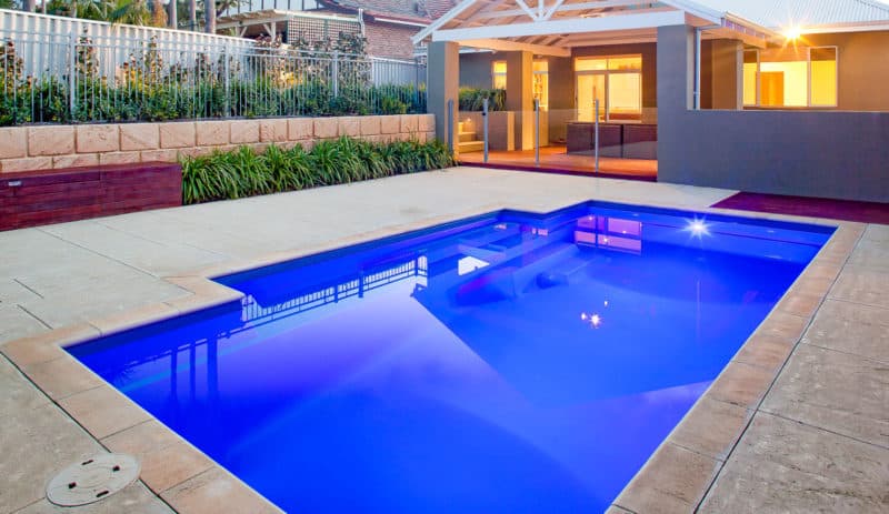 Modern swimming pool with LED lighting and automated controls.